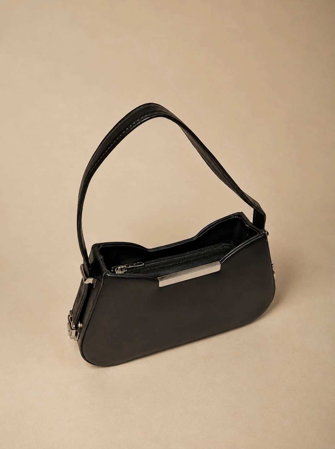 Elegant Minimalist Sling Bag with Curved Silhouette and Sleek Strap
